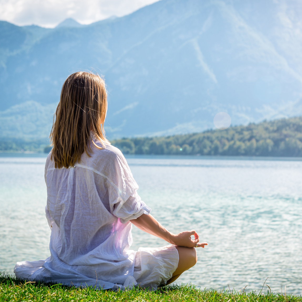 Woman meditating at the lake